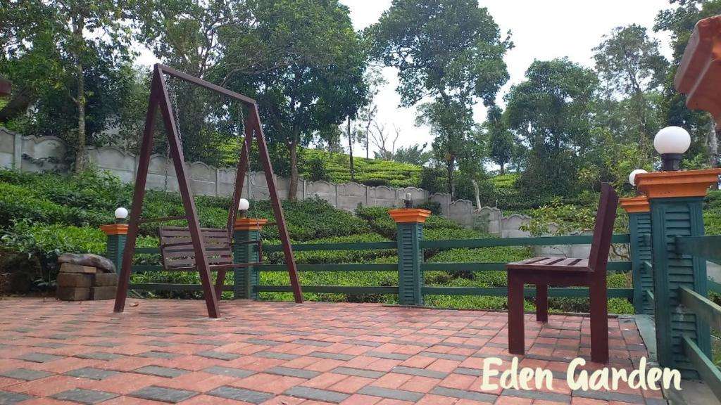 Paved patio with swings overlooking the tea gardens